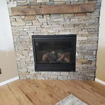 Stone fireplace with wooden mantle