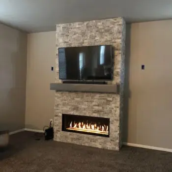Stone fireplace with mounted TV