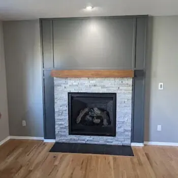 Modern fireplace with wooden mantle