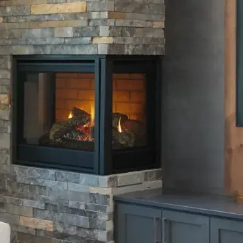 Stone fireplace with burning logs