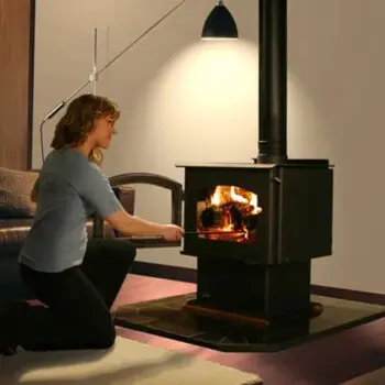 Person tending to indoor fireplace