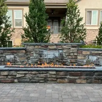Outdoor stone fireplace with flames