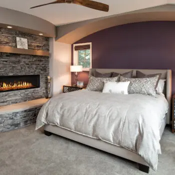 Modern bedroom with stone fireplace