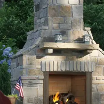 Stone outdoor fireplace with flames
