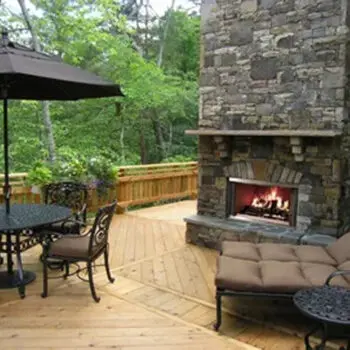 Outdoor deck with stone fireplace